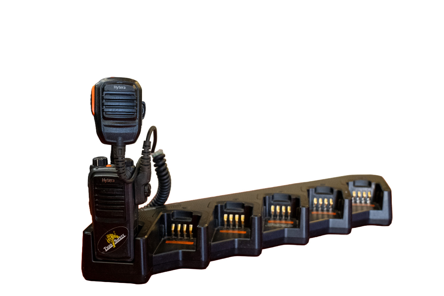Tiger Safety two-way radio with a speaker microphone seated in a multi-unit charging base