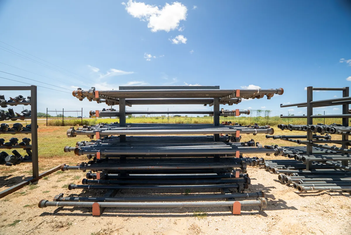 Racks of flow iron pipe joints stored in the Tiger Safety Rentals yard in Dilley, Texas