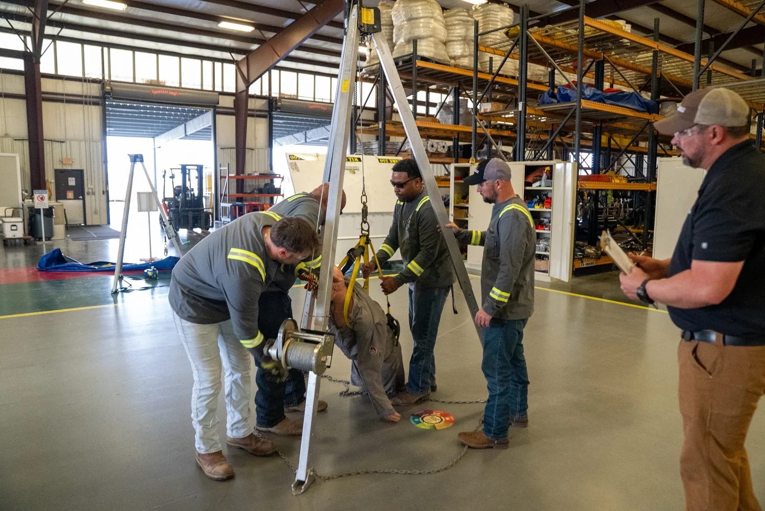 Tiger Safety Rentals crew setting up a tripod and winch for confined space rescue training