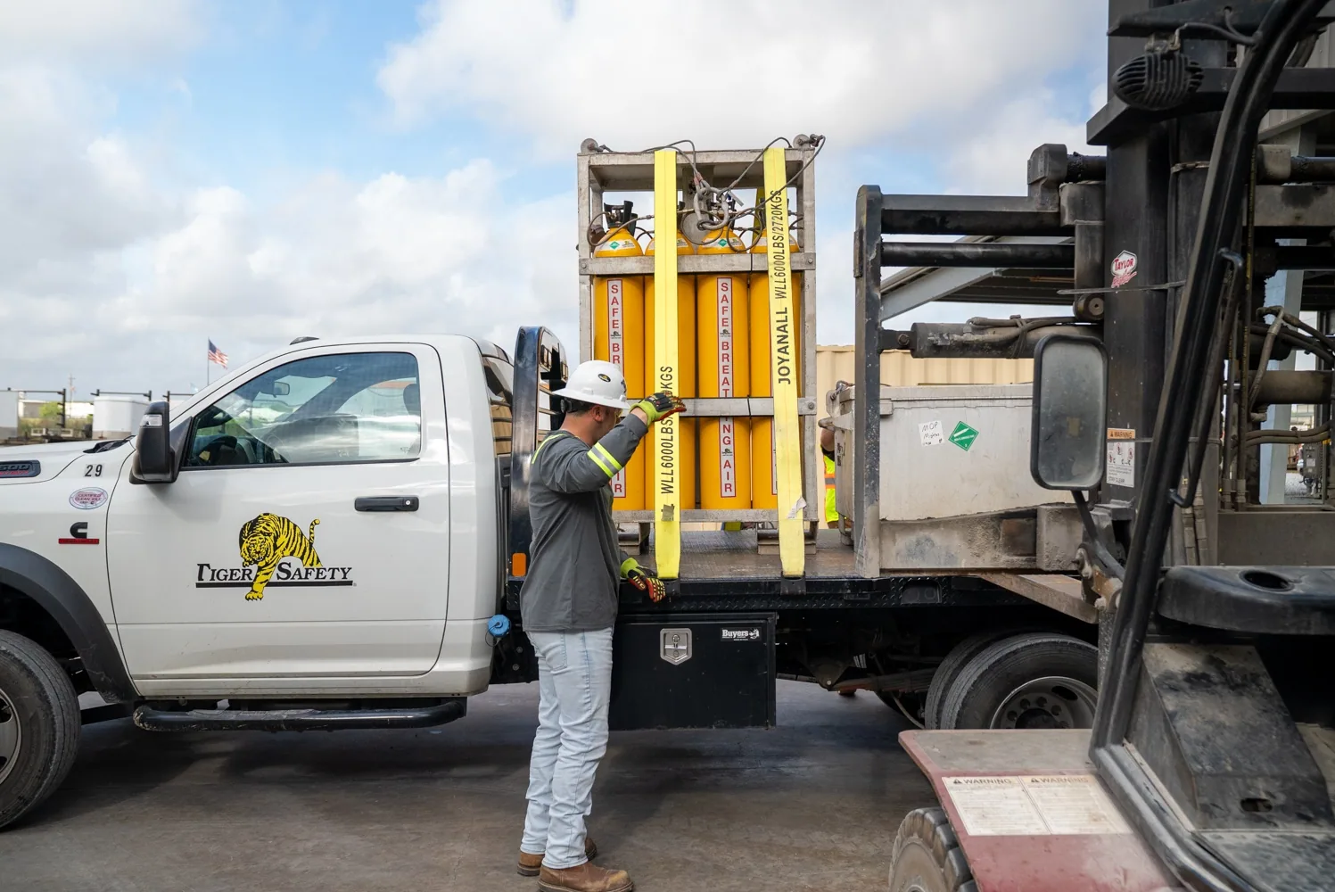 Tiger Safety Rentals technician securing breathing air cylinders on a Tiger Safety truck